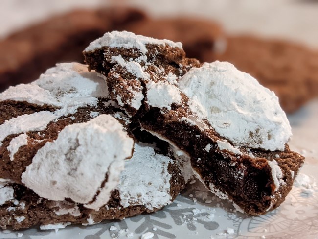 Several cookies covered in powdered sugar.