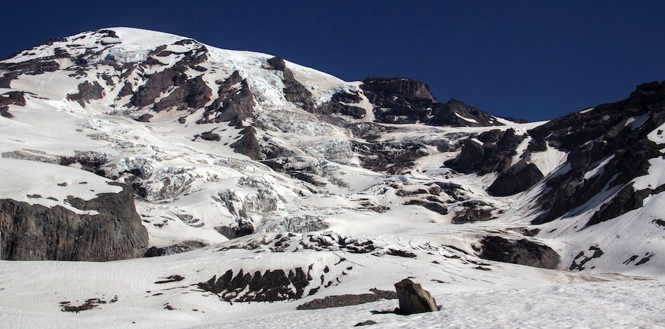 Snowy Alpine A glaciated and rocky mountain peak.