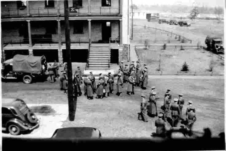 a group of soldiers sands outside of Barracks 74