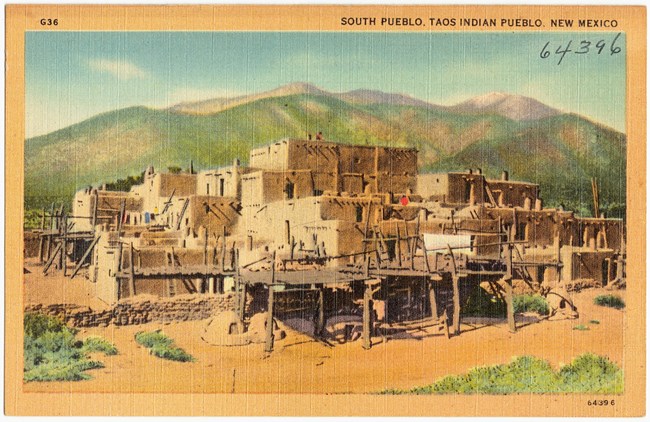 Historic postcard of adobe houses.