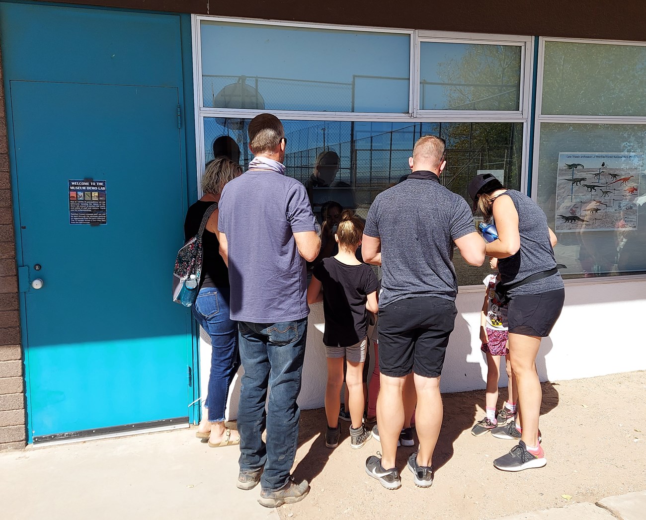 photo of a group of people outside the fossil demo lab window