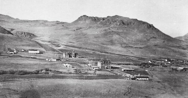 Aerial view of buildings in rural mountainous area.