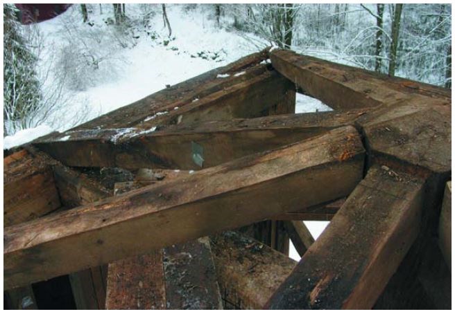 Deteriorating timber belfry support framing.