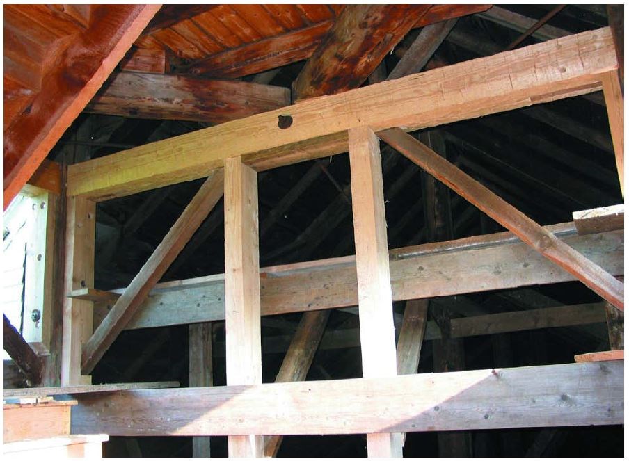 Light brown vertical and diagonal thick wood framing.