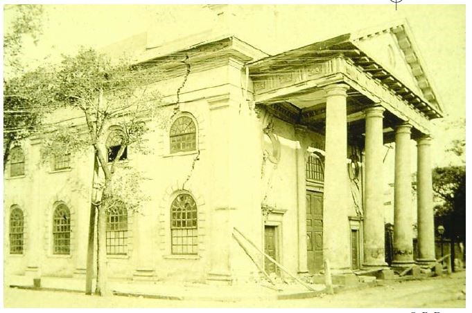 Historic photo large vertical cracks above two windows of a two-story Greek revival church with 4 columns.