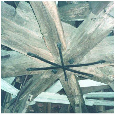 Three cross beams come together with black rod iron connecting bands.