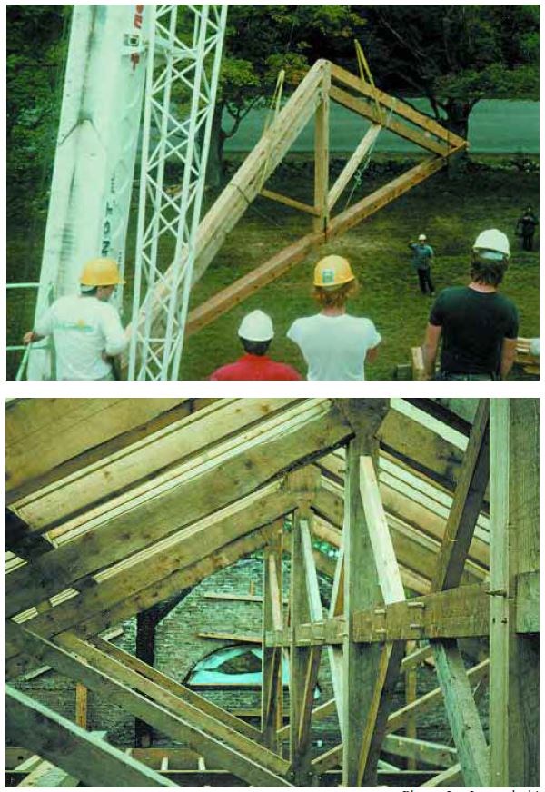 Two images. Top 4 men watch a crane move a triangle shaped truss.  Bottom interior view looking down row of trusses in place.