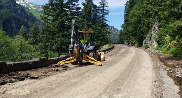 Stevens Canyon Road Construction A yellow construction vehicle sits upon a dirt road