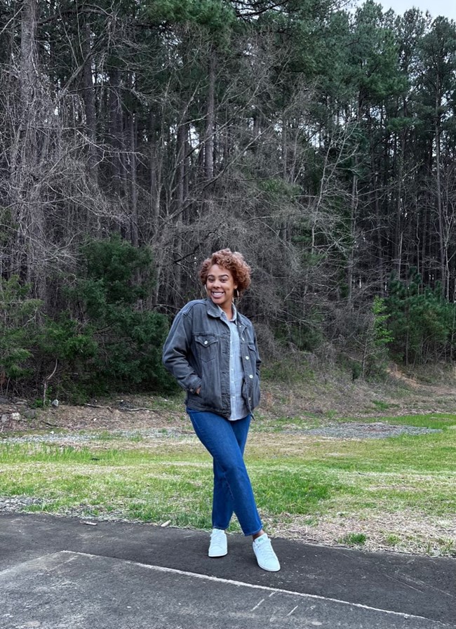 Subria Spencer Subria smiling while posing at a park surrounded by nature
