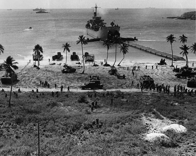 A LST ship off the shore of an island