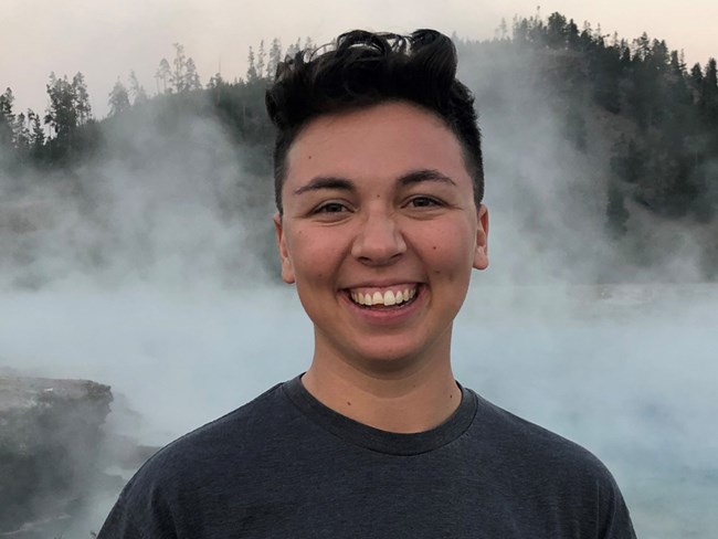 Portrait of a person standing outdoors in front of a steamy body of water