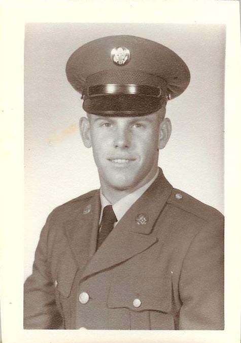 a man in a military uniform smiles at the camera