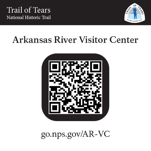 Sign with a black band at top, text, and QR code.