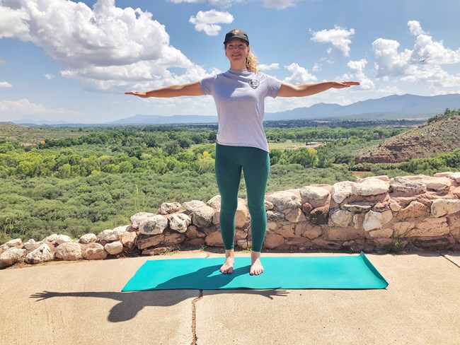 A Park Ranger demonstrates flying bird pose at Tuzigoot Pueblo. A Park Ranger demonstrates flying bird pose at Tuzigoot Pueblo.