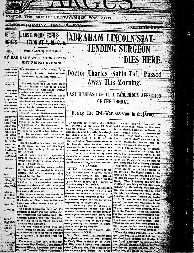 Large bold black letters, and smaller news print letters, on front page of newspaper