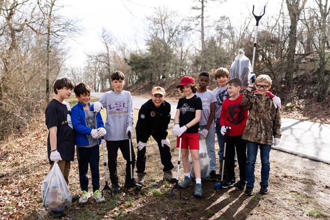 Tatum poses with youth volunteers during a trash clean up.