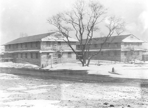 Two large buildings with simple wood paneling