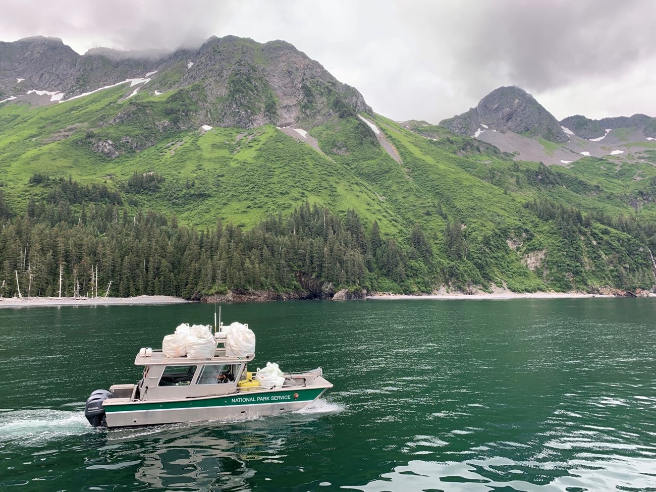 A boat is loaded with bags of marine debris and headed for Seward for disposal. A boat is loaded with bags of marine debris and headed for Seward for disposal.