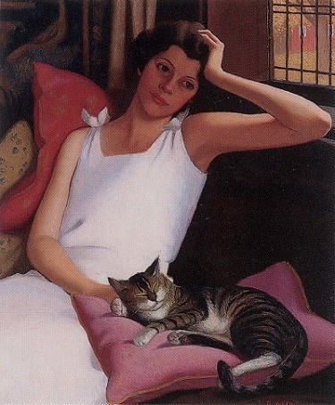 Theresa Knoche with Tommy, 1932 A women sitting in a chair with a cat laying on a pillow in front of her.