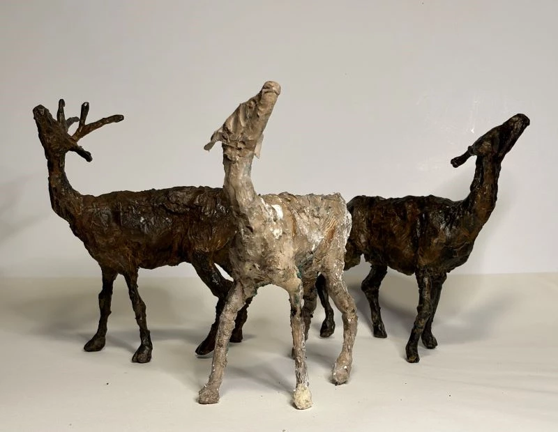 2_Three Deer Waiting_bronze and clay Three small deer sculptures looking upward
