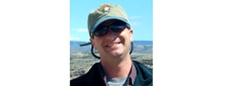 photo of a smiling man in nps ballcap and sweatshirt