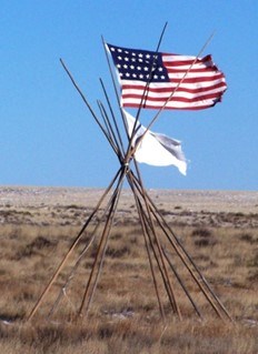 Flags wave over Sand Creek Massacre site as they did in 1864 A tipi frame at Sand Creek Massacre site with American and white flag of surrender beside it