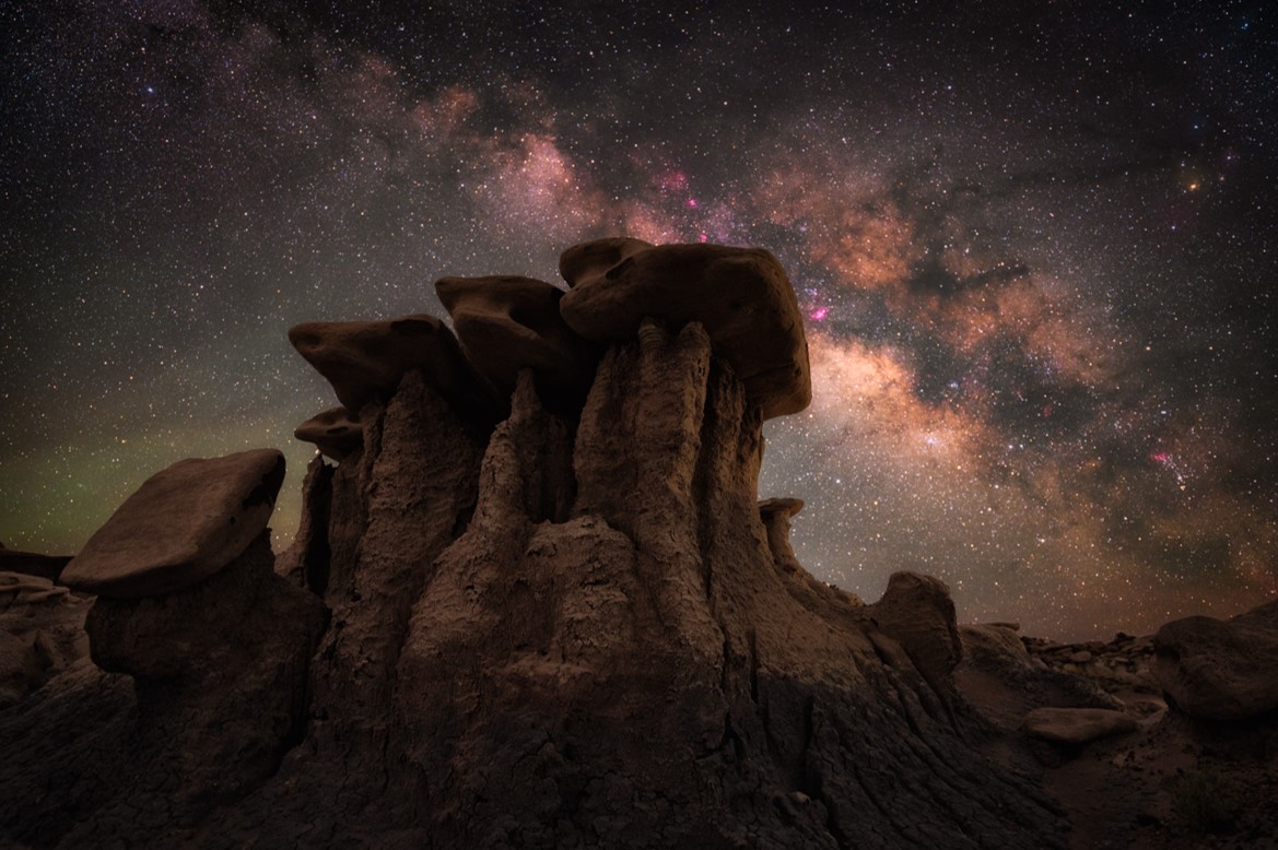 An image of the Milky Way beyond natural toadstool rock formations