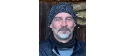 Todd Cherry Todd wearing a beanie, a goatee, and a warm vest over a long-sleeved baselayer.