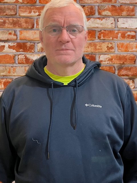 Tom Jacobs A portrait of a man wearing a sweatshirt.