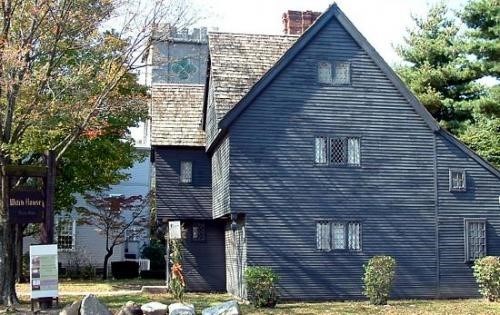 Trails & Sails Side view of seventeenth-century black clapboard home of three stories