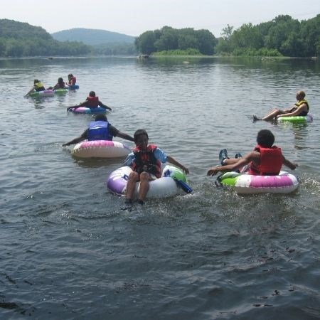 Youth tubing in a river.