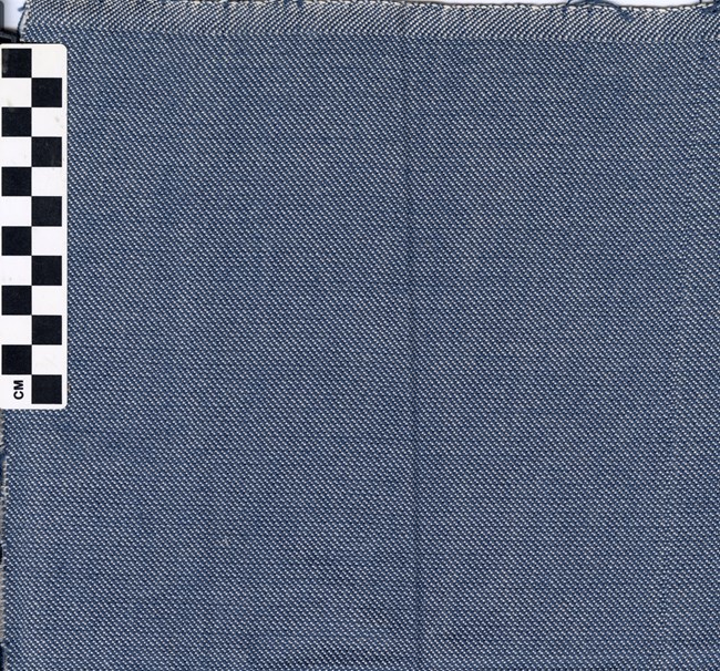 Twill Weave Sample_WR A blue cloth with a pattern that forms diagonal lines running from left to right. The lines alternate between blue and white