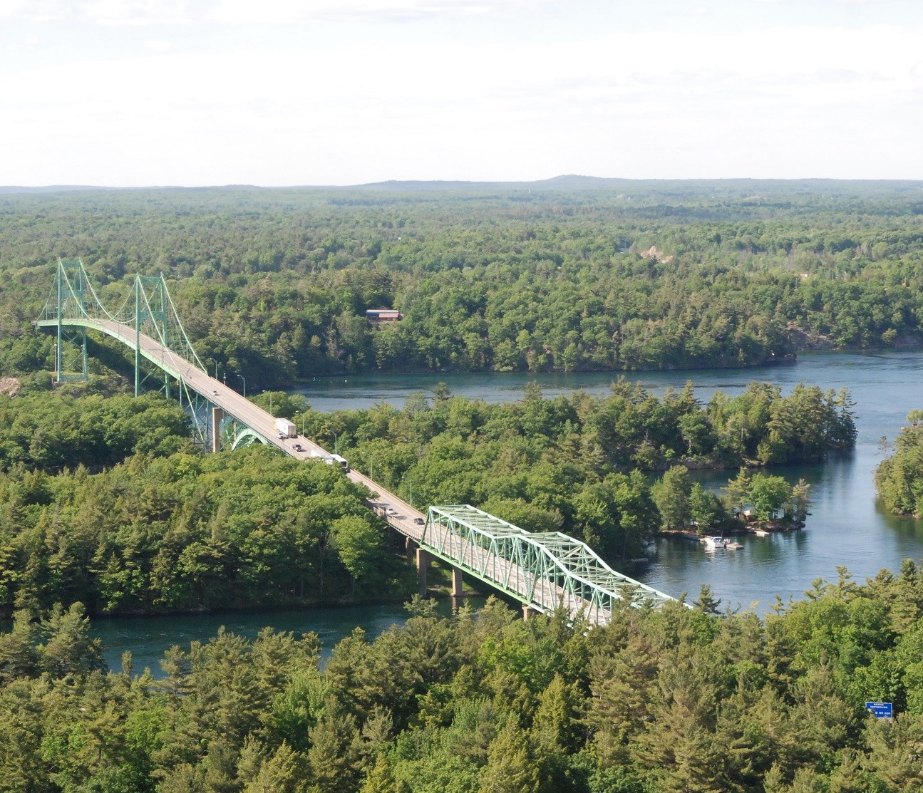 a bridge spans over a river and an island in the middle of the river.