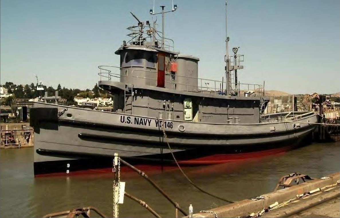 25 foot Gray tug boat with text reading U.S. Navy YT-146.