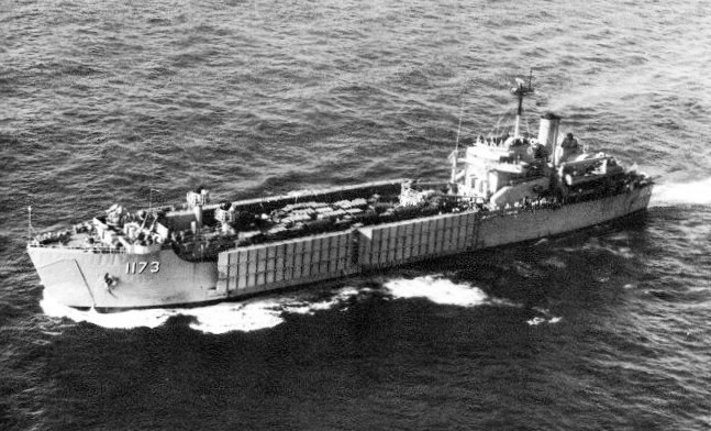 USS SUFFOLK COUNTY Black and white photo of a long ship traveling at sea