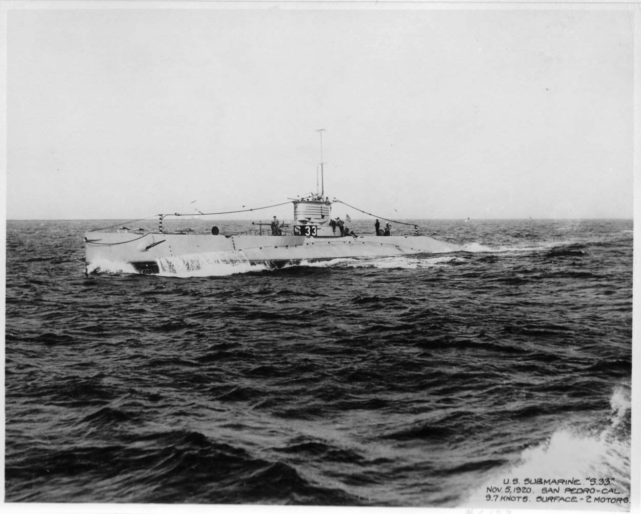 large submarine above the water line, in the ocean.