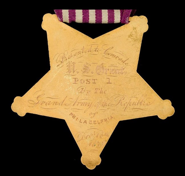 U.S. Grant GAR Badge Back - Smithsonian National Museum of American History Gold five-point star shaped Grand Army of the Republic Badge awarded to U.S. Grant.