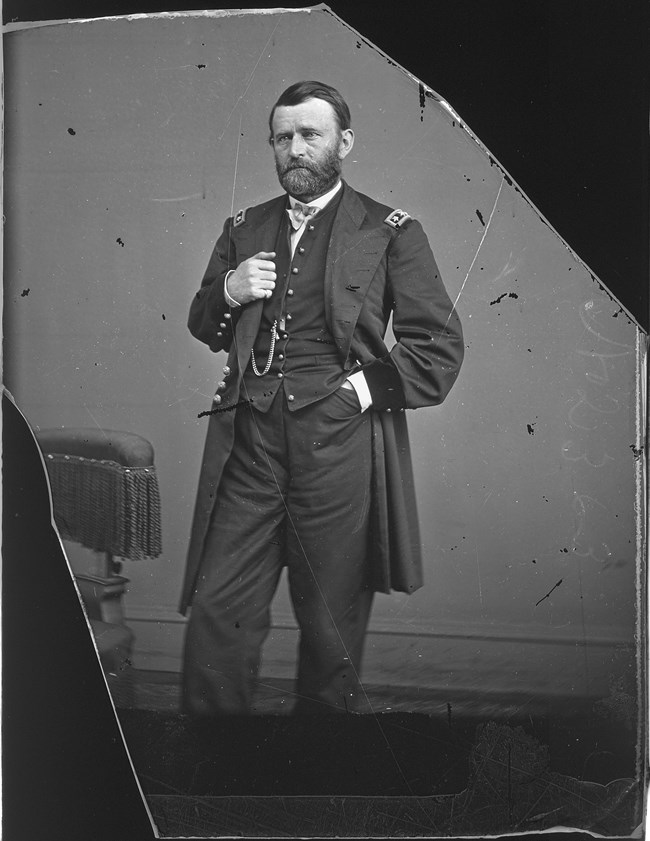 Black and white portrait of US Grant in uniform standing facing left