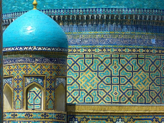 Colorful tile work is highlighted on a building in Uzbekistan.