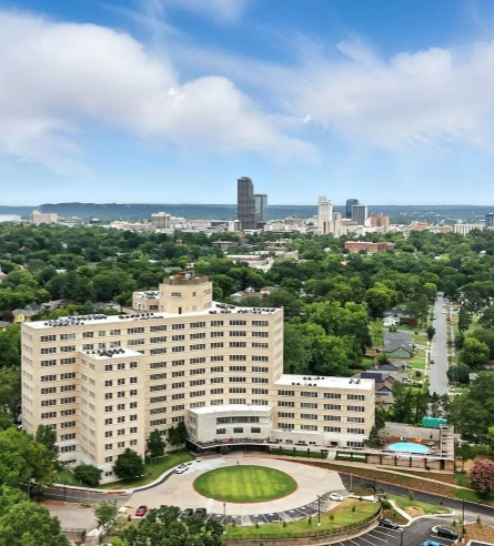 A large multistory midcentury building now repurposed as an apartment complex.