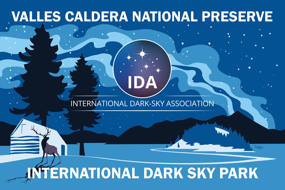Image of elk standing in front of the Valle Grande with the words Valles Caldera National Preserve, International Dark Sky Association, and International Dark Sky Park. Image credit - Tyler Nordgren.