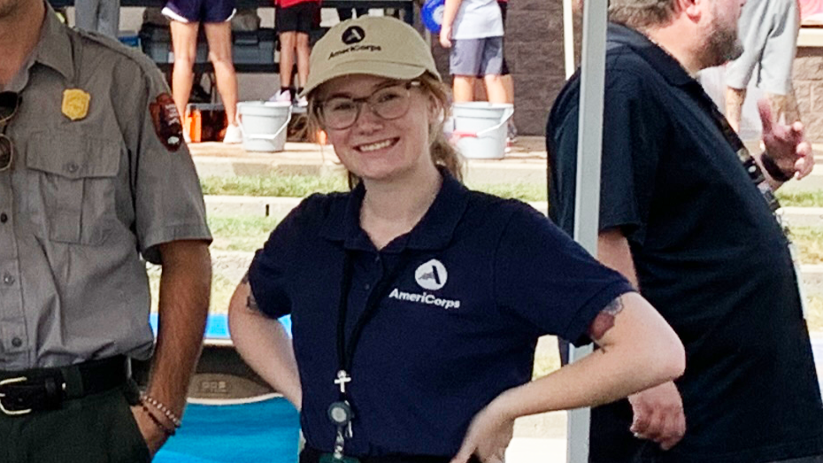 VCOteamWorldofWater woman in AmeriCorps shirt and hat
