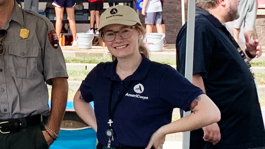 woman in AmeriCorps shirt and hat