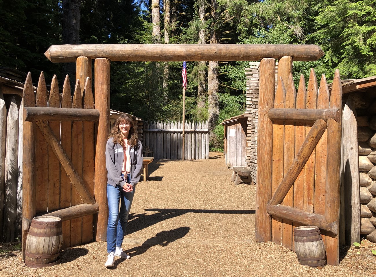 woman in front of log gates