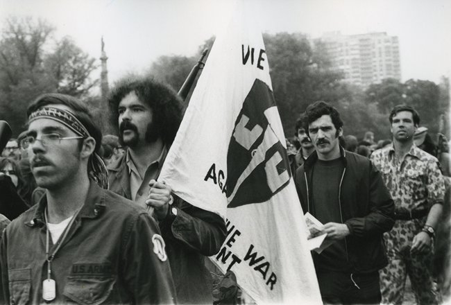 VVAW-BostonCommon-CopyrightDianaMaraHenry marchers, with close ups of three men, one carrying a Vietnam Veterans Against the War flag