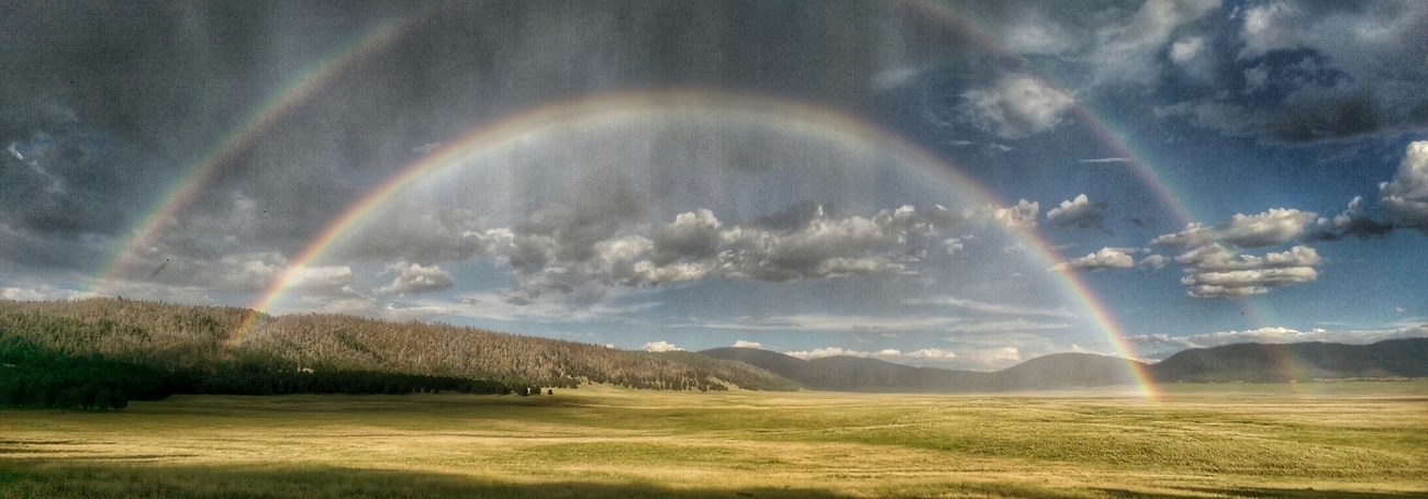 Rainbow over a vide grassy plain