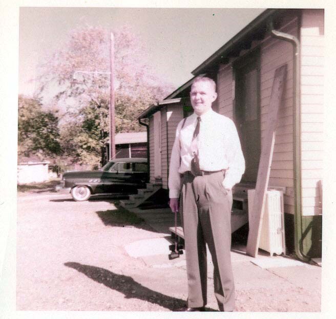 a man stands in front of military quarters
