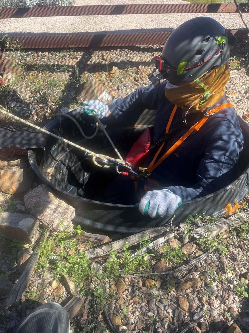 Bat Surveys a person in climbing gear repeals into a small culvert in the ground