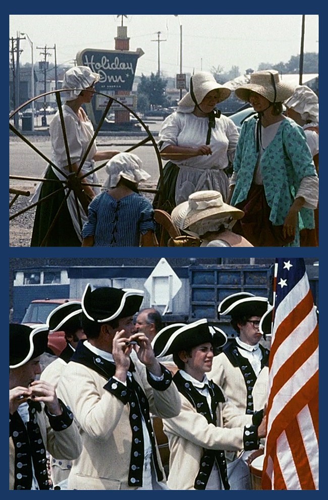 Several Continental Soldiers stand in line. The one one the far right carries and American flag.