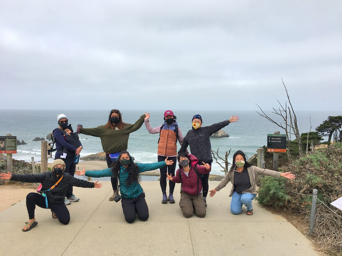 First in person gathering! Group of womxn pose for a socially distanced group photo at a scenic spot above the Sutro Baths.